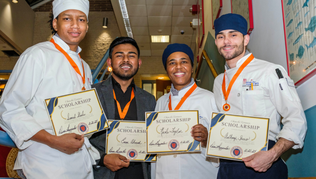 Culinary students holding up scholarships